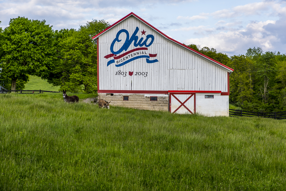 A view of a picturesque red, white and blue Ohio Bicentennial Barn that was painted in 2003 in Vinton County, Ohio.